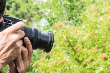 Fototapeta premium photo camera in photographer hand shooting