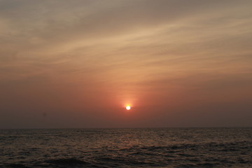 sun set touches the clouds and kiss the ocean to say i am just behind the clouds !!!