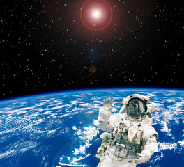 Astronaut and earth on the backdrop. The elements of this image furnished by NASA.