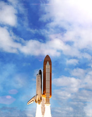 Powerful rocket is flying through the clouds to stars. Elements of this image furnished by NASA.