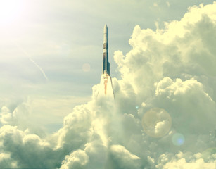 Powerful rocket is flying through the clouds to stars. Elements of this image furnished by NASA.