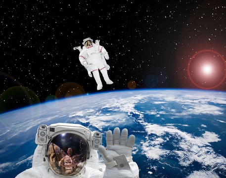 Astronauts flying in outer space. Space scene. The elements of this image furnished by NASA.