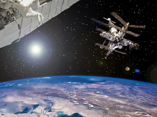 Space station and spaceship above the earth. The elements of this image furnished by NASA.