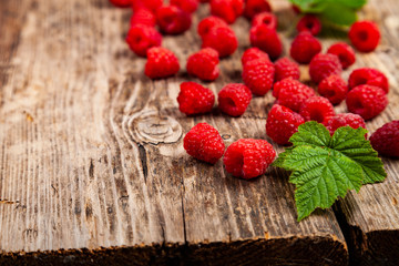 Ripe raspberry on an old wooden table.