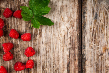 Ripe raspberry on an old wooden table.