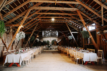 Interior of an old wooden hall with decorated tables. - 276101336