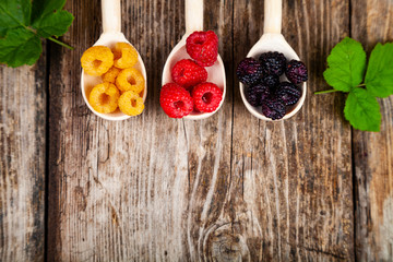 Ripe raspberry on an old wooden table.