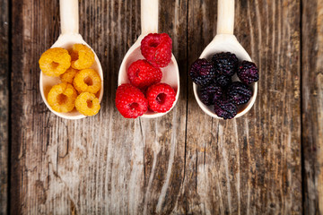 Ripe raspberry on an old wooden table.