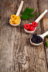 Ripe raspberry on an old wooden table.