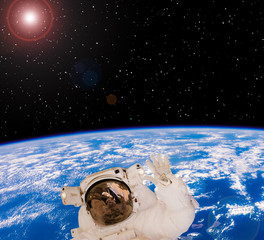 Astronaut in outer space. Earth globe and stars. The elements of this image furnished by NASA. © wowinside