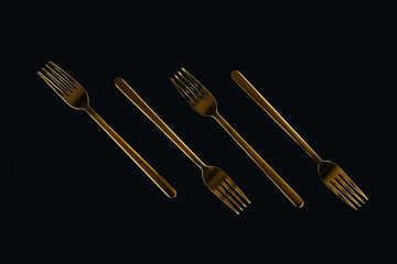 close-up of four metal forks isolated on black