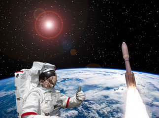Astronaut and rocket above the earth. Space concept. The elements of this image furnished by NASA. © wowinside