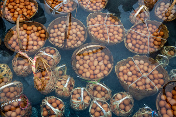 Boil the eggs in the basket of hot water.