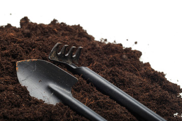 pile of soil with garden toos isolated on white background - Image .