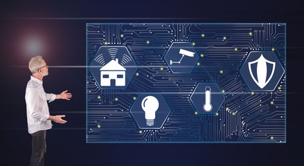 A smart home concept explained by a businessman on a wall screen