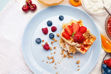 Plate with delicious waffles with fresh strawberry