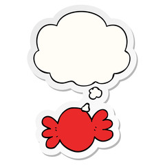cartoon wrapped candy and thought bubble as a printed sticker