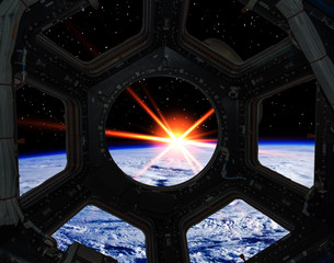 Sunrise from the window of a spaceship. Elements of this image furnished by NASA.