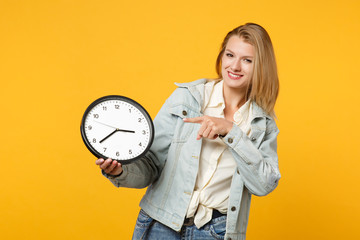 Portrait of beautiful young woman in denim casual clothes looking camera, pointing index finger on...