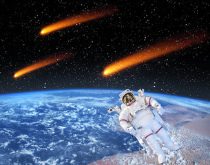 Earth and comets above. Astronaut posing in front. The elements of this image furnished by NASA. - Powered by Adobe