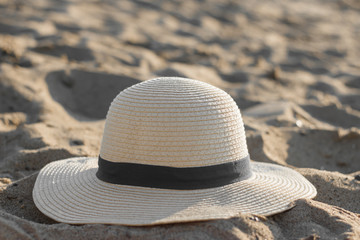 Fototapeta na wymiar Bright beach hat on the sand.