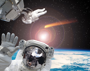 Astronaut waving in front. Comet on the background. The elements of this image furnished by NASA.