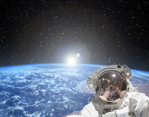 Obraz na płótnie Canvas Astronaut makes selfie against sunrise. The elements of this image furnished by NASA.
