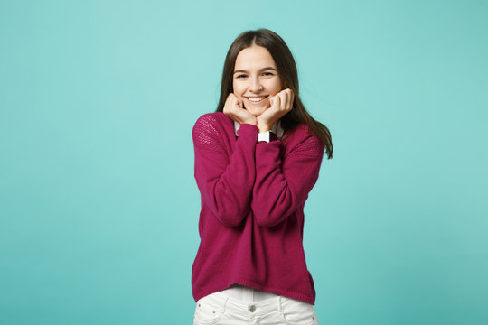 Young brunette woman girl in casual clothes posing isolated on blue green turquoise wall background studio portrait. People sincere emotions lifestyle concept. Mock up copy space. Looking camera smile