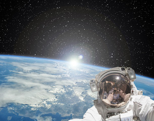 Obraz na płótnie Canvas Astronaut makes selfie against sunrise. The elements of this image furnished by NASA.