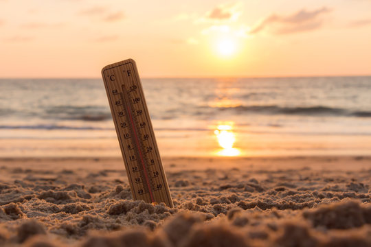Close-up of thermometer on the sand showing high temperature.