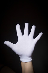 White gloved hand showing number five