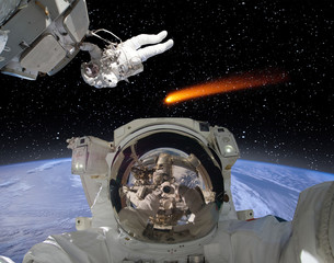 Astronauts and comet. The elements of this image furnished by NASA.