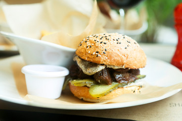 Beef burger with pickles and truffle sauce