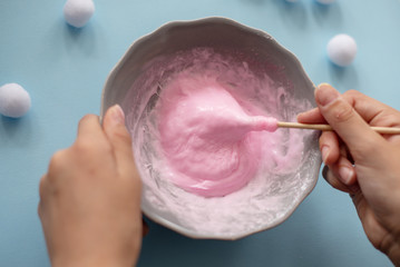Fototapeta premium a girl making slime herself. child making slime. 