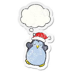 cute christmas penguin and thought bubble as a distressed worn sticker