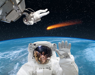 Astronaut waving in front. Comet on the background. The elements of this image furnished by NASA.