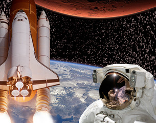 Rocket flies from earth to Mars. Astronaut in outer space. The elements of this image furnished by...