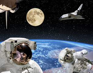Astronauts, spaceships and moon. Earth on the backdrop. The elements of this image furnished by NASA.