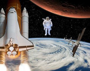 Rocket flies from earth to Mars. Astronaut in the distance. The elements of this image furnished by NASA.