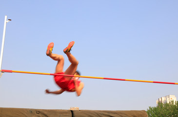 men high jump athletes in the playground