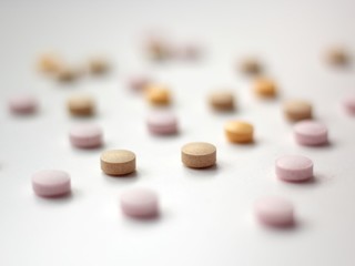 Closeup of colourful pills on white background. 