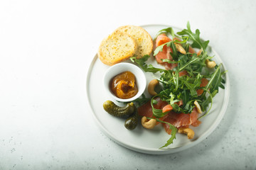 Smoked salmon arugula salad with pickles