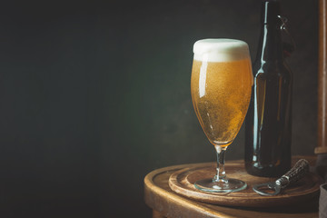 Glass beer on dark background with copy space