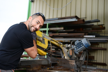 Fototapeta na wymiar handsome man working in a workshop steel industry factory construction metallurgy machine site