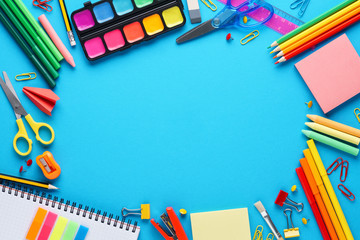 Various colorful stationery on blue background. Back to school.
