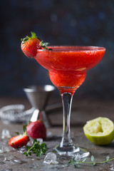 Ice Strawberry alcohol cocktail with lime and rum in a glass