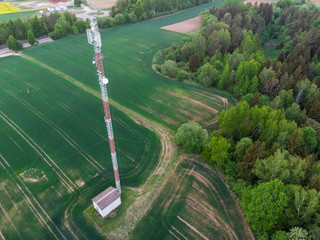 Aerial shot of mobile tower in green fields