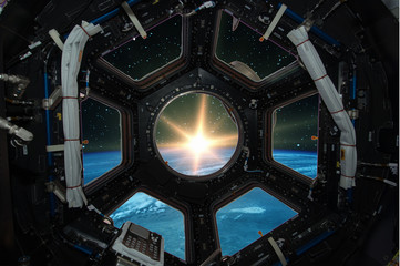 Fascinating sunrise on earth. Spaceship window view. Elements of this image furnished by NASA.