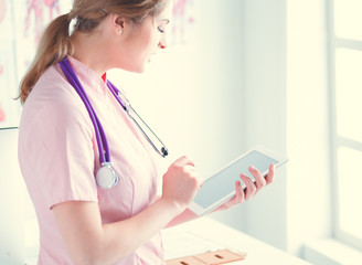 Doctor woman checking medical data on tablet pc