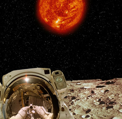 Astronaut posing on extrasolar planet. Earth on the background. The elements of this image...